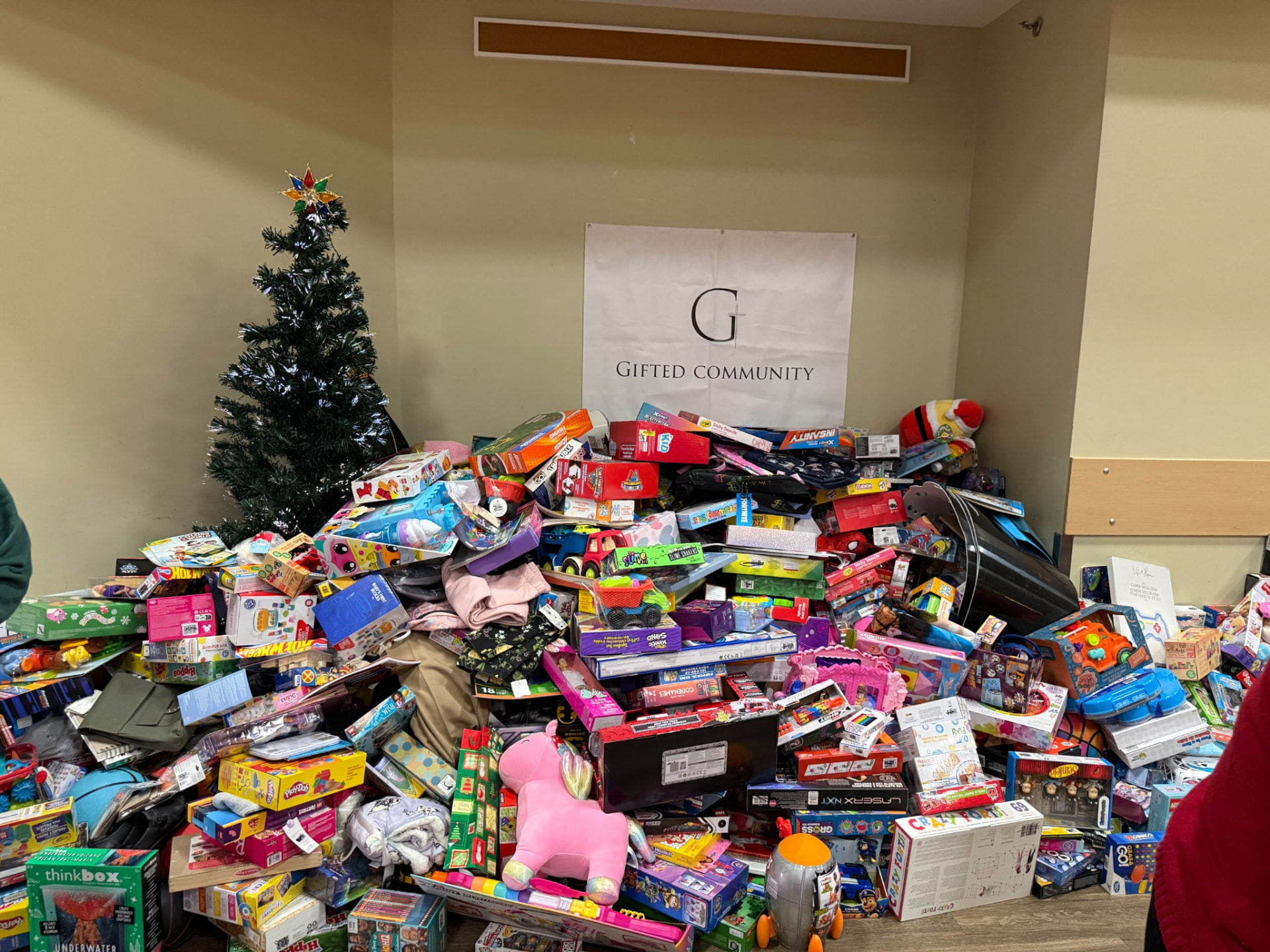 A large mountain of donated Christmas gifts collected for local kids