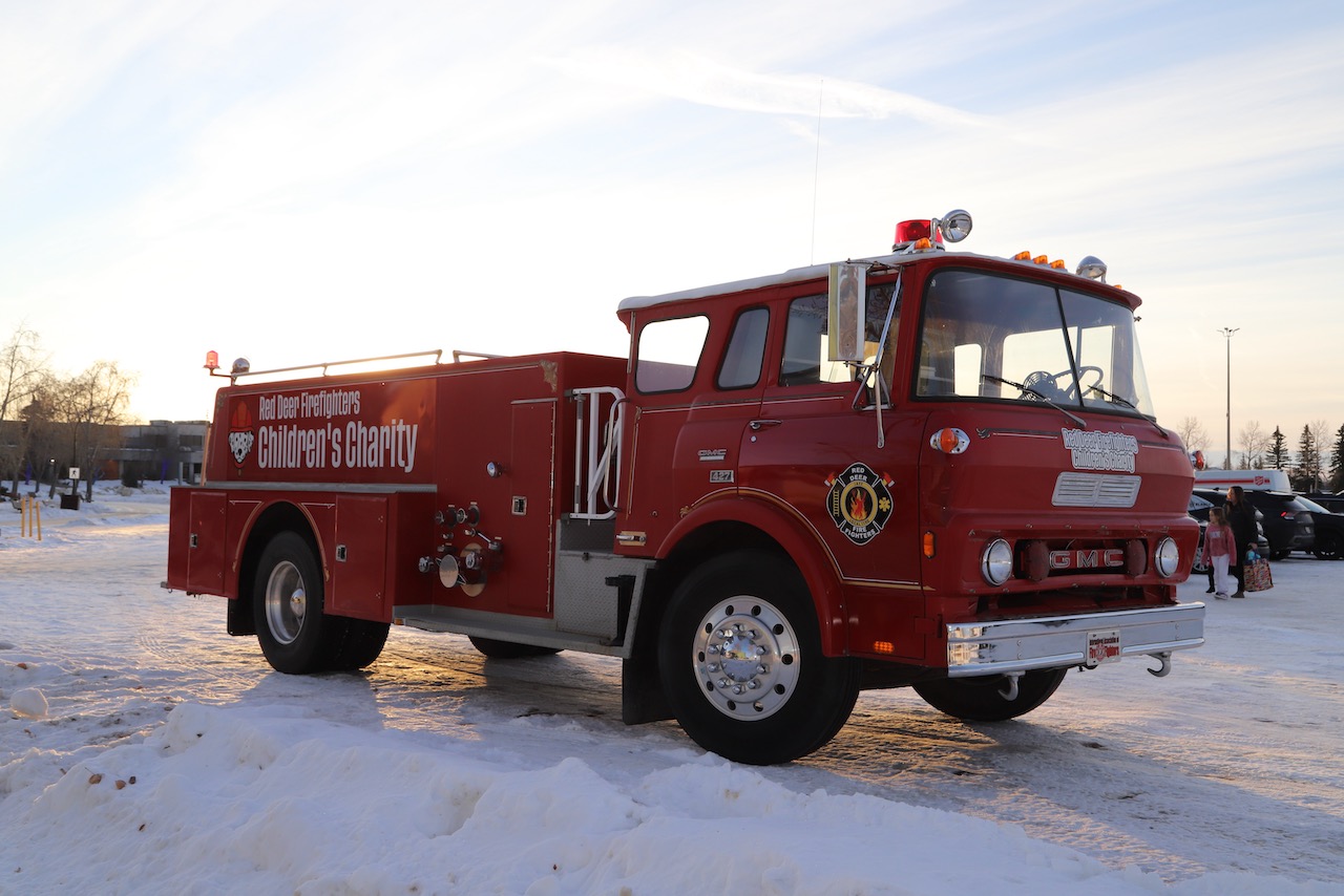 Red Deer Firefighters' Children's Charity vintage red fire truck parked in the snow at the Christmas Wish Breakfast