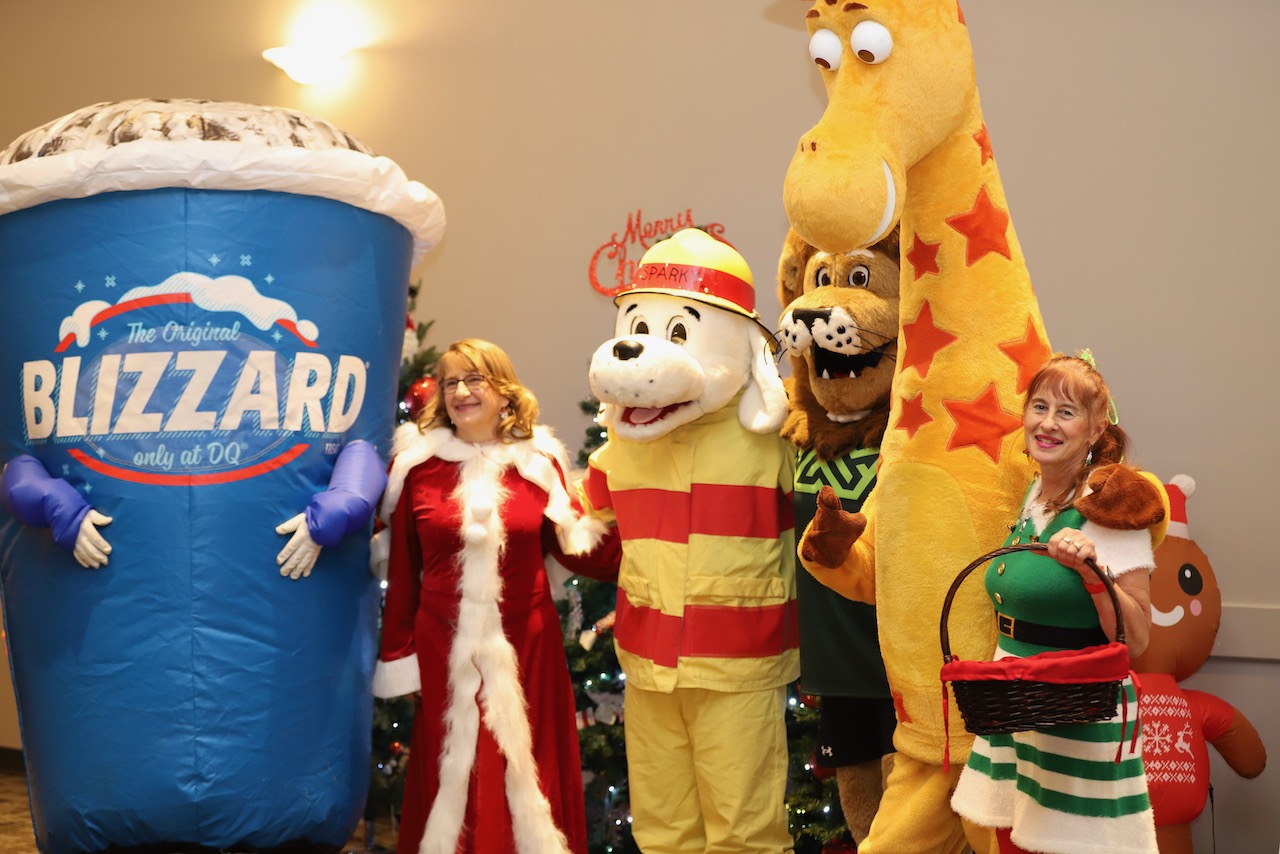 Mrs. Claus, Sparky the fire dog, Blizzard and other Christmas characters greeting families